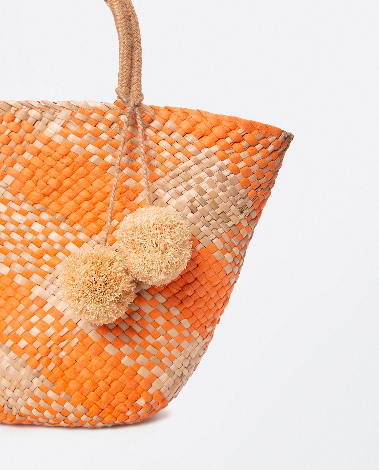 Jute basket with handles and pompoms. Stripes. Orange
